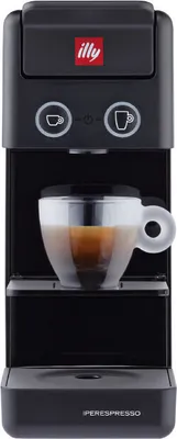 A black Illy coffee machine with a cup of coffee on the drip tray.