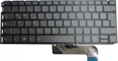 A close-up view of a laptop keyboard with a ribbon cable attached.