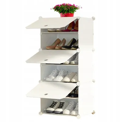 A white modular shoe rack with several shelves, each containing shoes. A potted plant with pink flowers sits on top.
