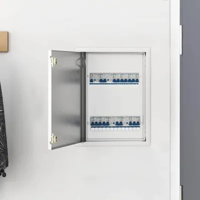 An open electrical distribution box mounted on a white wall.