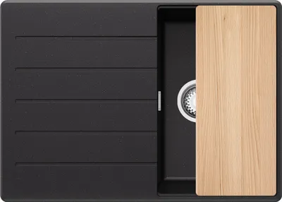 A top-down view of a black granite kitchen sink with a wooden cutting board partially covering the sink basin.