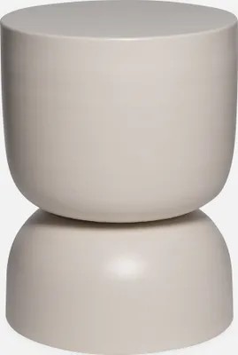 A studio shot of a cream-colored side table.