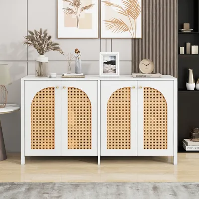 A white sideboard with cane doors is displayed in a room with artwork on the wall.