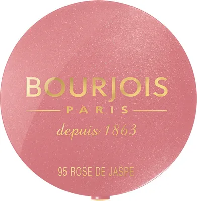 A close-up, top-down view of a round makeup compact.