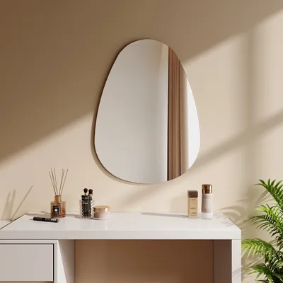 A modern vanity setup with a mirror, makeup brushes, and skincare products.