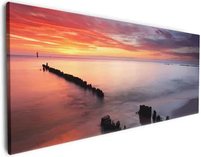 Produktbild von Wallario Premium Leinwandbild Sandstrand im Sonnenuntergang - Roter Himmel in Größe 60 x 150 cm