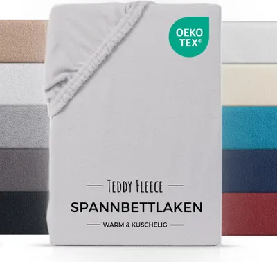 A folded fitted sheet with a swatch of other colors behind it.