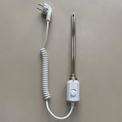 A white electric heating element with a coiled cord and a white plug is placed on a light gray background.
