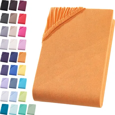 A folded orange fitted sheet is shown on a white background, with a swatch of smaller colored fitted sheets displayed to the left.