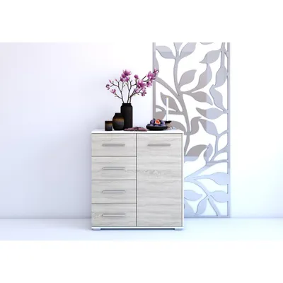 A modern chest of drawers with decorative elements on top, placed against a white wall.