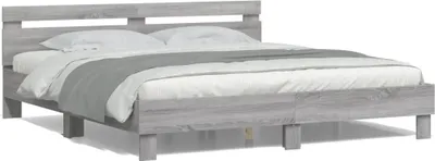 A gray wooden bed frame with white bedding.
