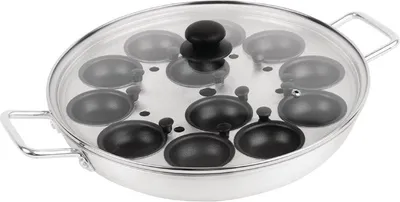 A close-up, studio shot of a stainless steel egg poacher with a glass lid.