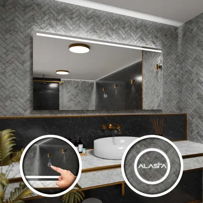 A modern bathroom vanity with a large LED-lit mirror, a white sink, and gold fixtures.