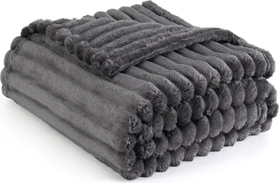 A folded dark gray fluffy blanket with a ribbed texture is shown on a white background.