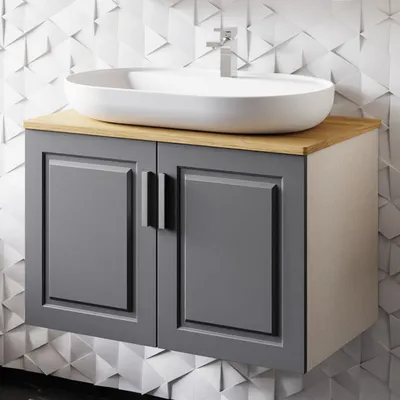 A bathroom vanity set with a sink and cabinet against a textured wall.