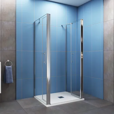 A modern bathroom with blue tiled walls and a glass shower enclosure.