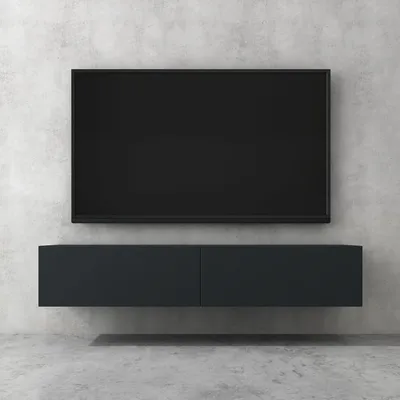 A modern television and media console mounted on a concrete wall.
