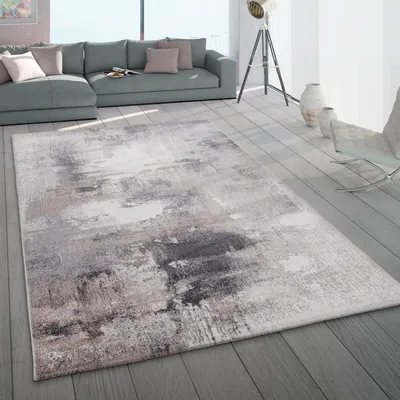 A modern living room with a sectional sofa and a rug.