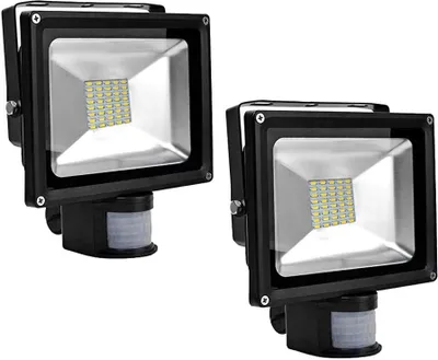 Two black LED floodlights with motion sensors are shown against a white background.