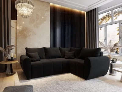 A modern black sectional sofa in a well-decorated living room.