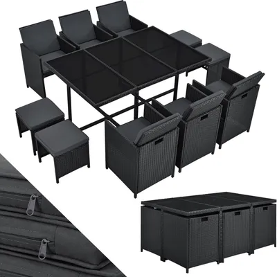 A black polyrattan garden furniture set with a glass-topped table, chairs, and stools.