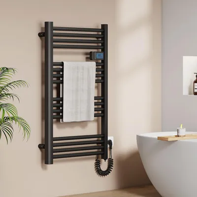 A modern bathroom with a black electric towel warmer, a white bathtub, and a plant.