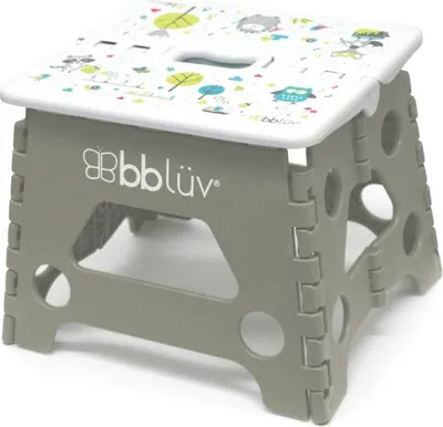 A folding step stool with a cartoon animal and tree pattern on the top surface.