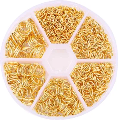 A circular plastic container with six compartments, each filled with gold-colored jump rings for jewelry making.