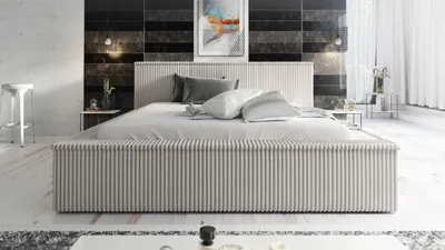 A modern bedroom with a bed, nightstands, and artwork.