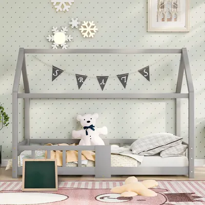 A child's bed in a room decorated with snowflakes and a banner.