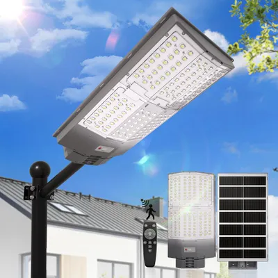 A solar-powered street light with a remote control and solar panel, set against a backdrop of a house and sky.