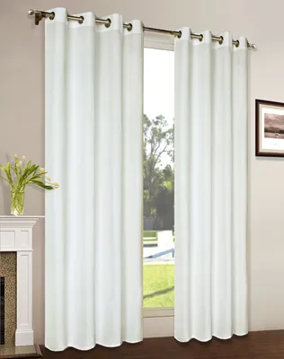 A room interior with white curtains covering a window, a fireplace on the left, and a framed picture on the right wall.