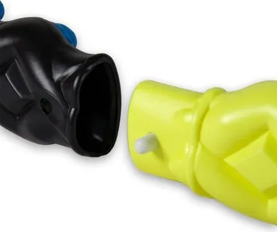 A close-up view of two parts of a hula hoop, one black and one yellow, about to be connected.