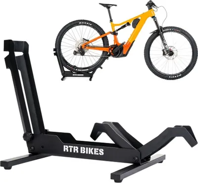 A black bicycle stand is shown in the foreground, with a yellow and orange electric mountain bike displayed above and behind it.
