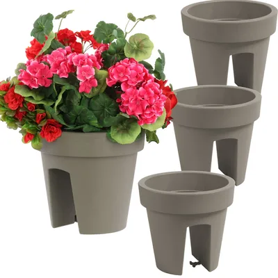 A set of three grey balcony planters, one filled with pink and red flowers and green leaves, against a white background.