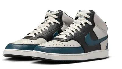 A pair of Nike Court Vision Mid NN sneakers are shown against a white background.
