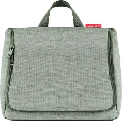 A gray toiletry bag with green zippers and a handle is shown against a white background.