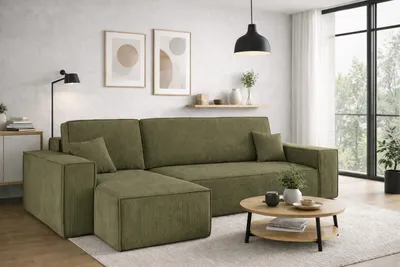 A modern living room with a green sectional sofa, coffee table, and artwork on the wall.