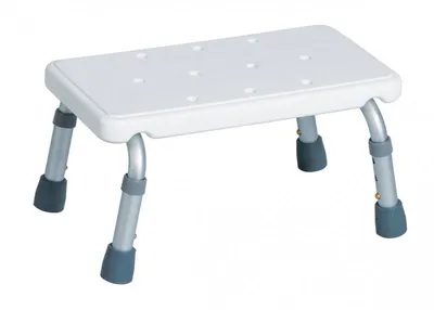 A white bath stool with adjustable silver legs and dark gray feet, shown against a white background.