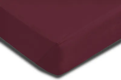A close-up view of a burgundy fitted sheet, showing the corner with elastic.