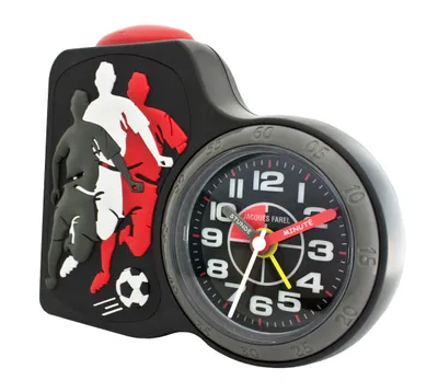 A close-up of a black alarm clock with a soccer theme.