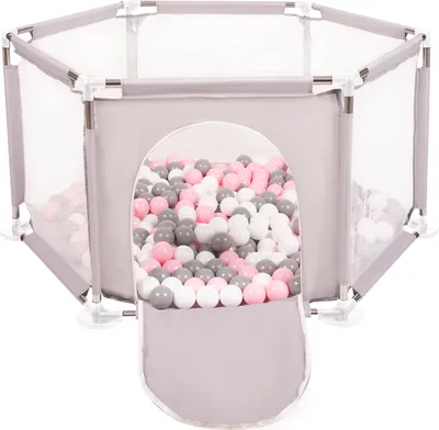 A hexagonal playpen filled with pink, white, and gray balls, with an opening in the front.