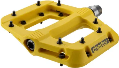 A yellow bicycle pedal with black pins and a silver threaded spindle.