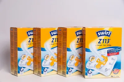 Four boxes of Swirl vacuum cleaner bags are lined up against a white background.