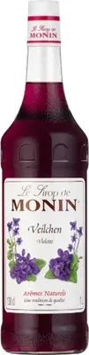 A bottle of Monin Violet syrup with violet flowers depicted on the label.