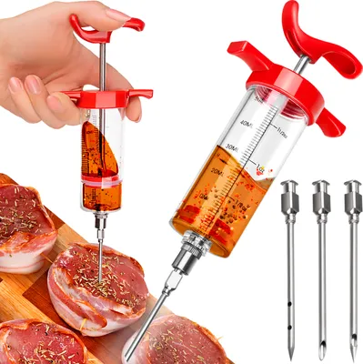 A hand is holding a meat injector syringe filled with marinade, with several pieces of meat wrapped in bacon in the foreground.
