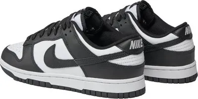 A pair of black and white Nike Dunk Low Retro sneakers.