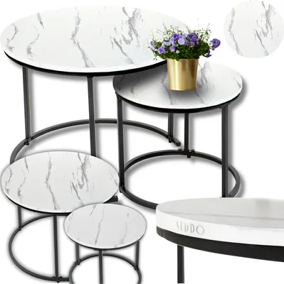 A set of nesting coffee tables with a marble-like pattern and gold accents, along with a small vase of flowers.