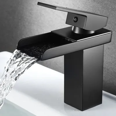 A black waterfall faucet is shown in use, with water flowing into a white sink.