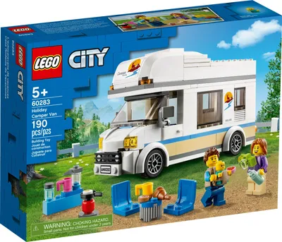 The image shows the packaging of a LEGO City Holiday Camper Van set, with the camper van and minifigures displayed on a grassy background with trees and mountains.